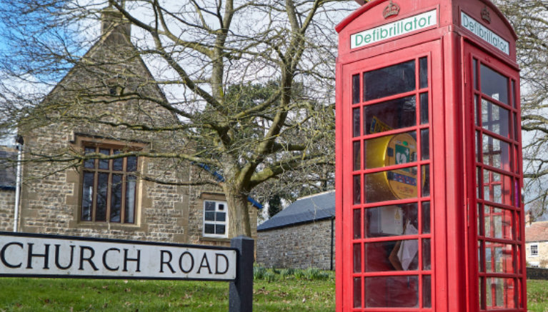 British red telephone booth near dry stone walls