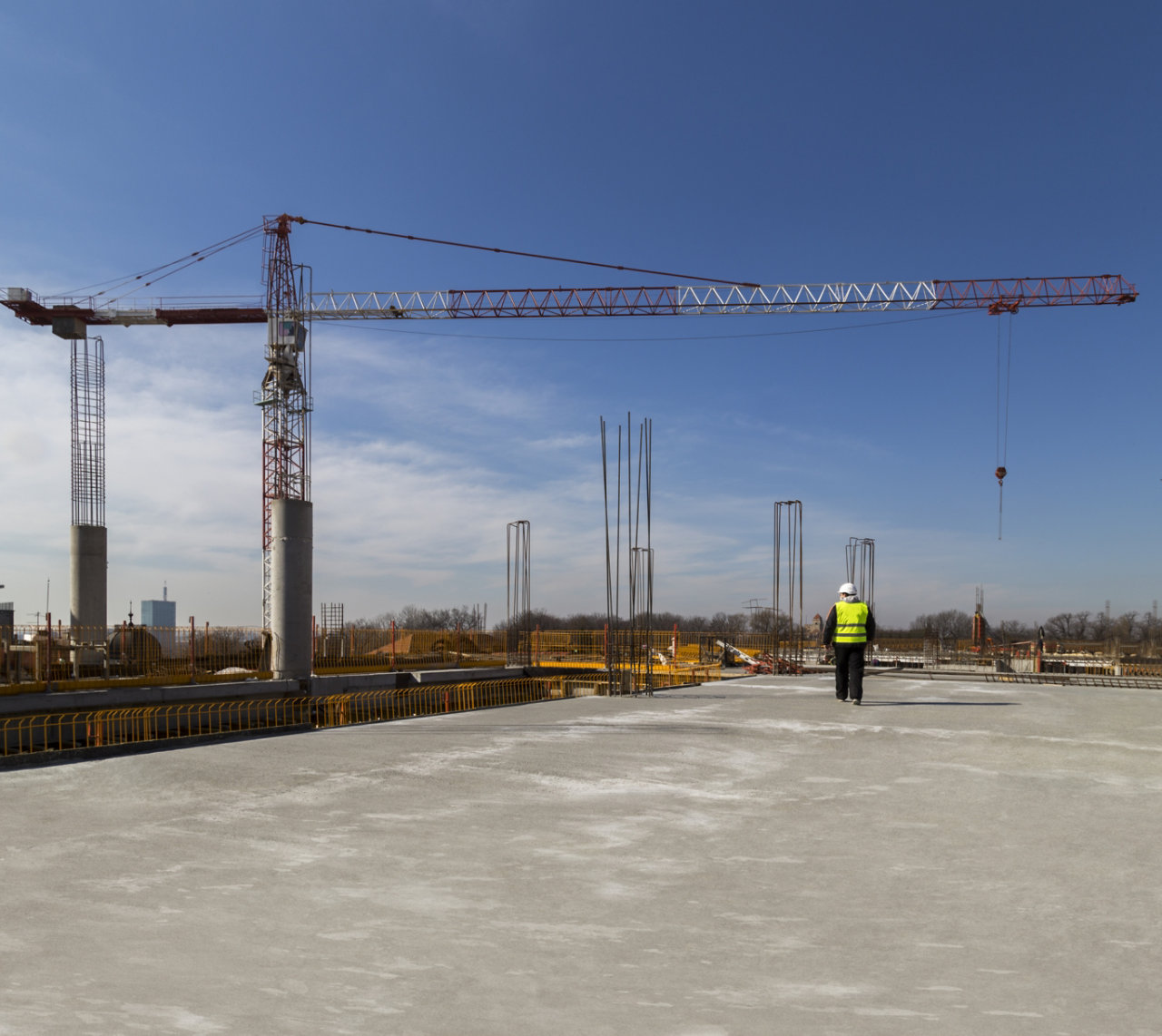 Worker walking below a crane