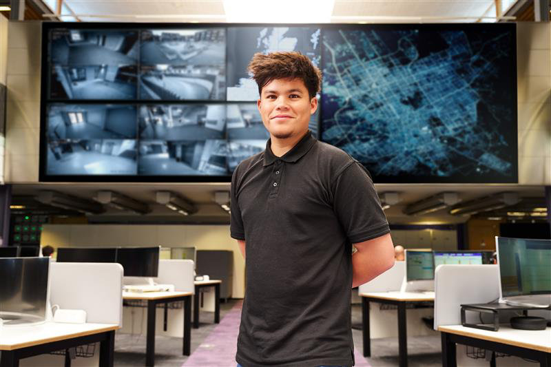 A male stood in front of security monitors