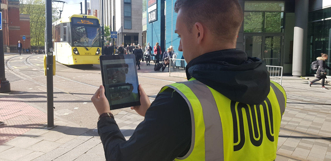 Transport for Manchester operative holding tablet computer