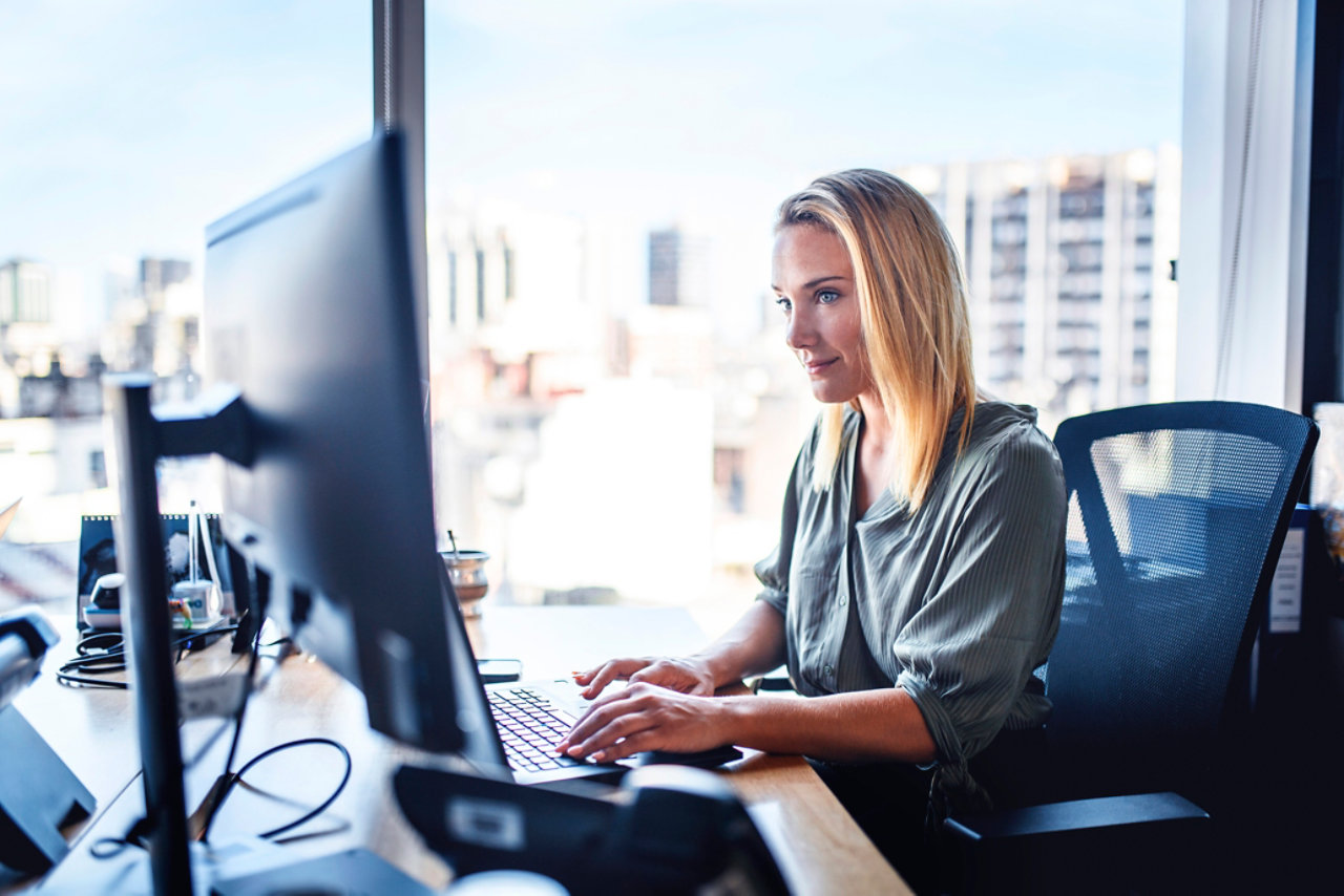 Woman at desk workinf on laptop