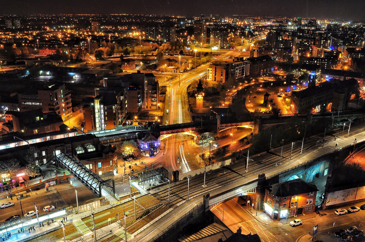 Aerial view of illuminated cityscape against sky