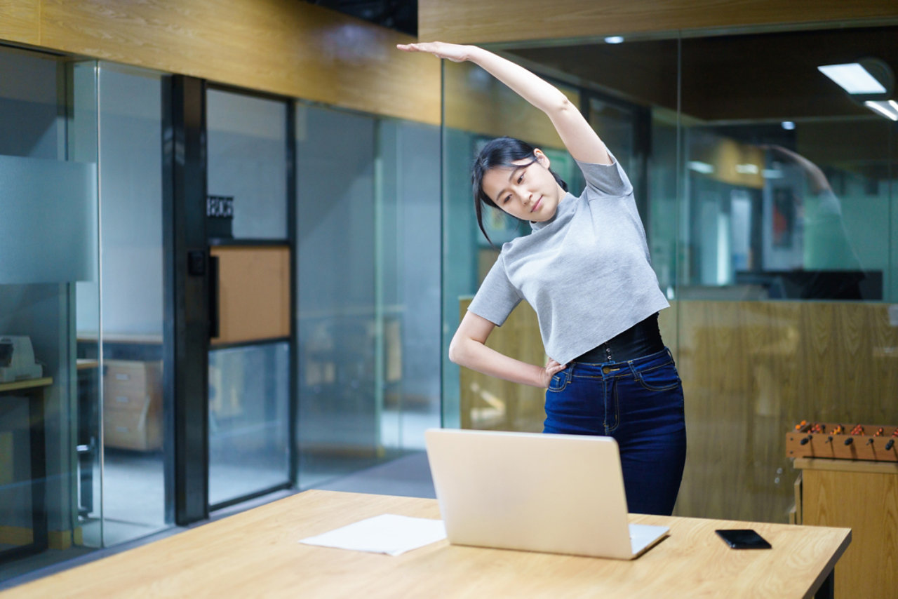 person doing exercise at work using video conferencing