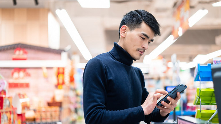 asian man checkout in supermarket