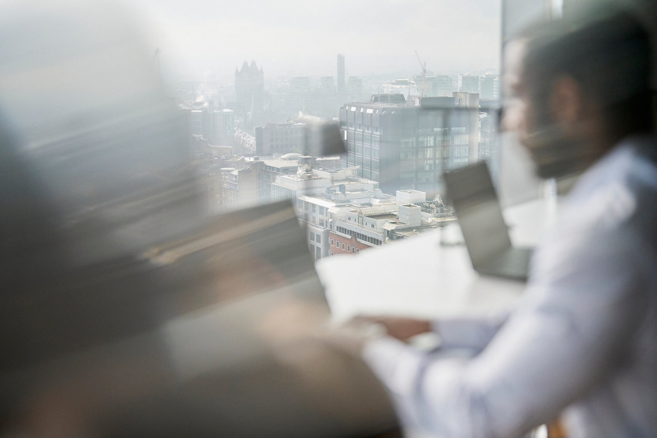 office workers working in front of window with city view