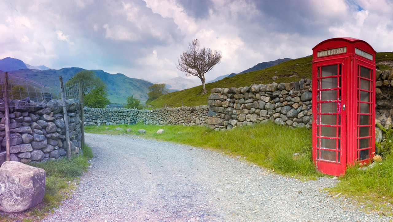 British red telephone booth near dry stone walls