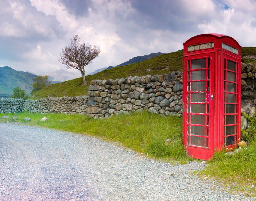British red telephone booth near dry stone walls