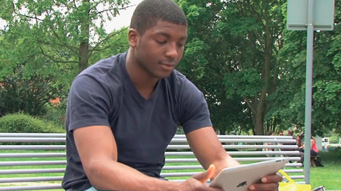 Image of a student looking at a tablet