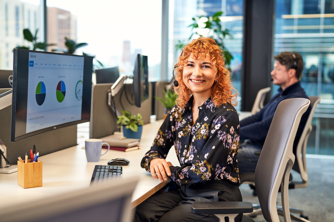 seated smiling woman at desk