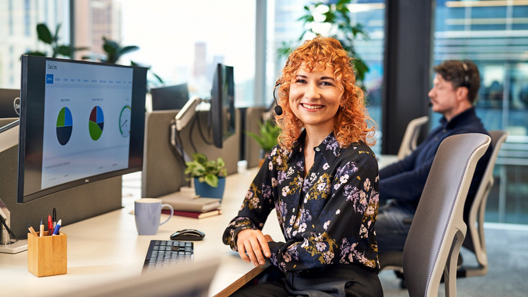 seated smiling woman at desk