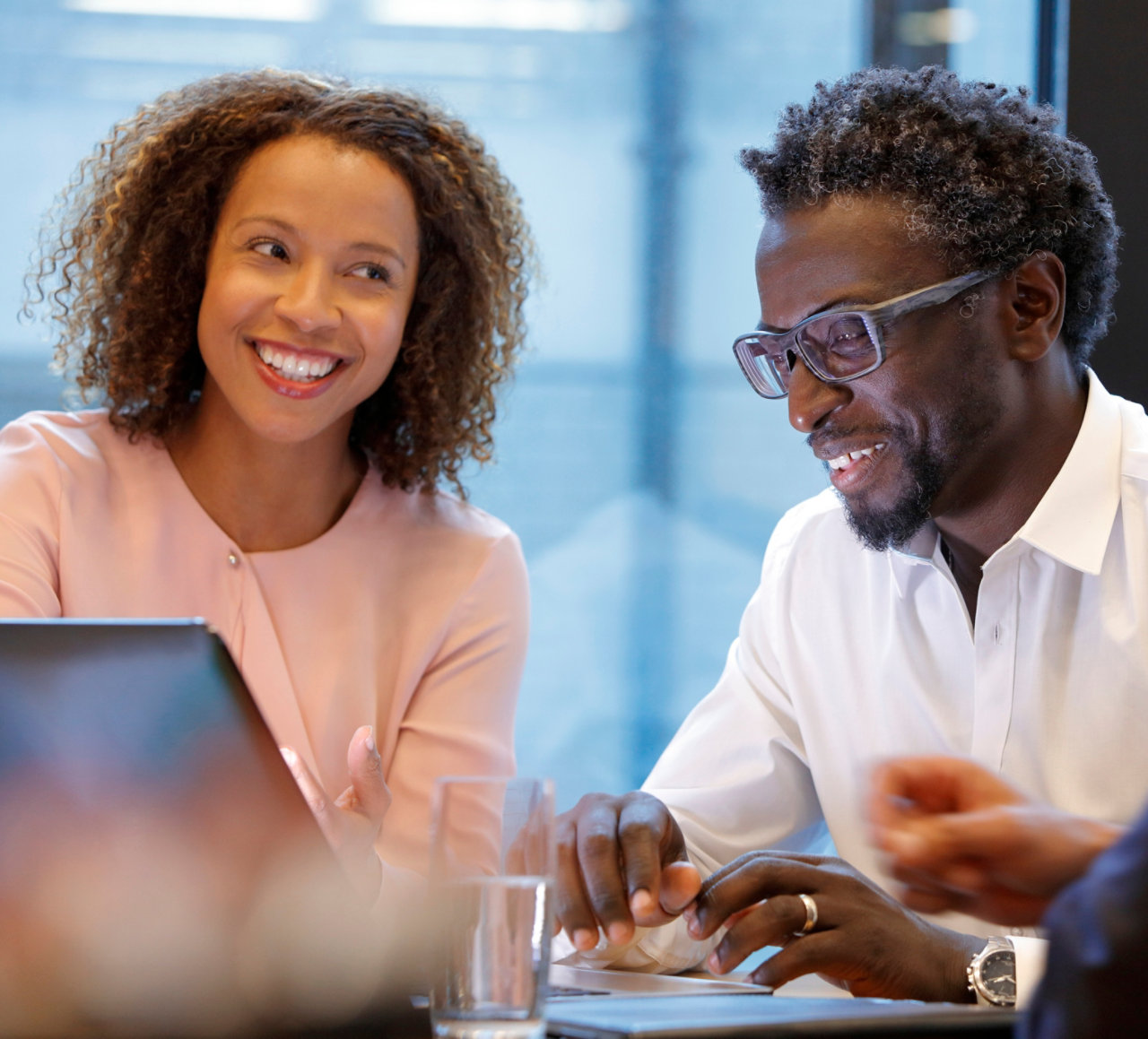 Colleagues talking at a desk