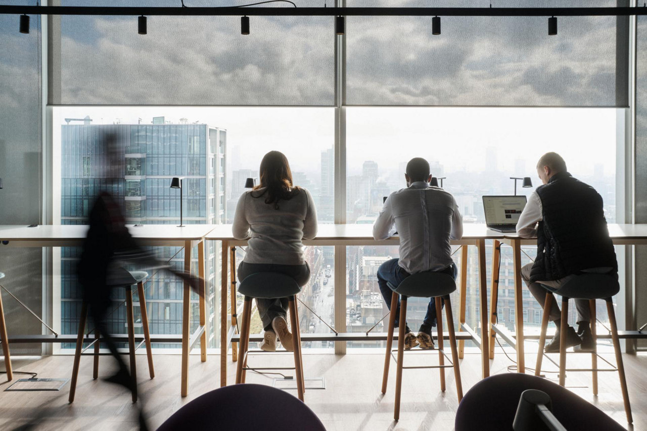 business people sitting on a desk with city view