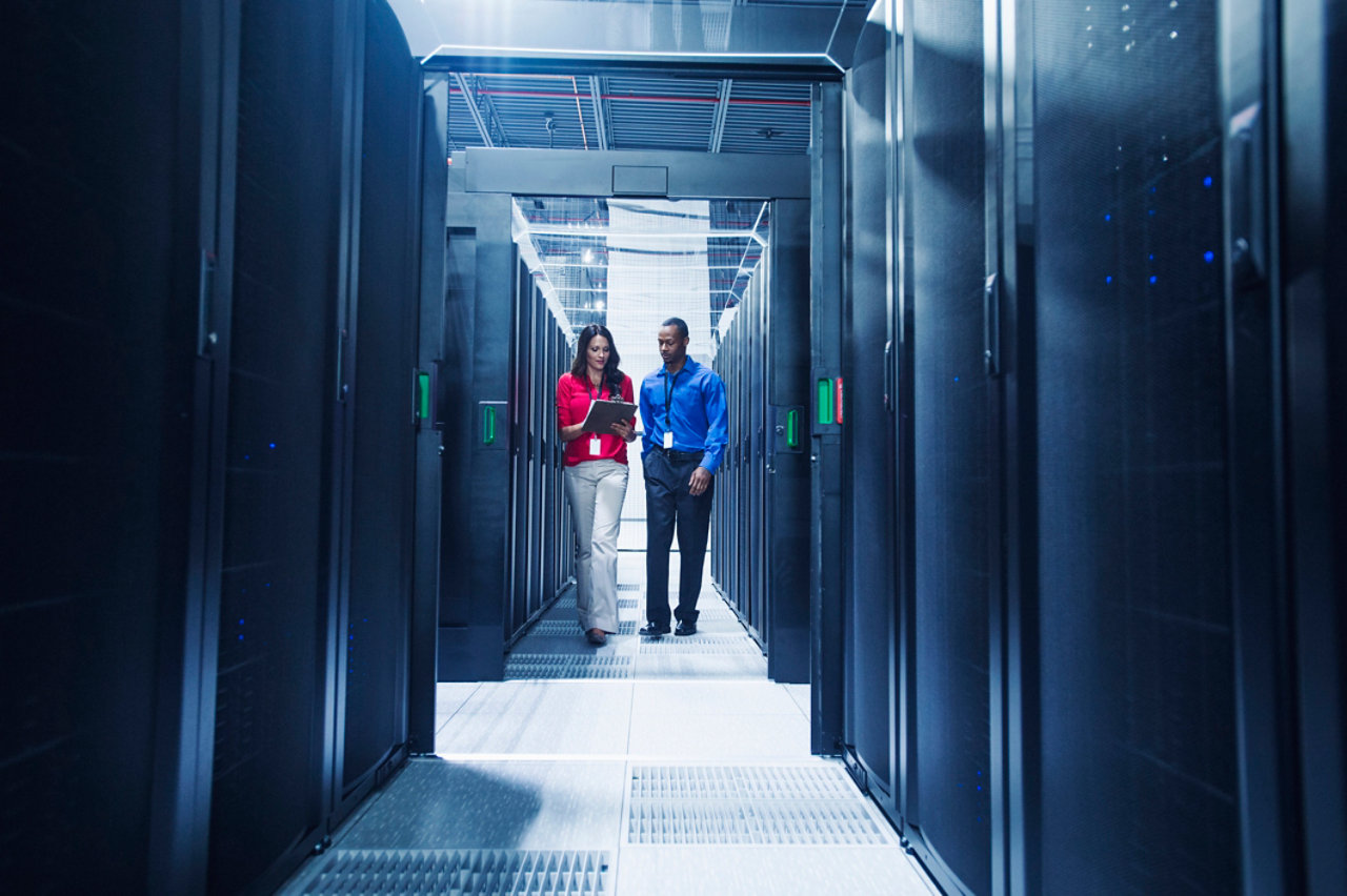 Business people talking in server room