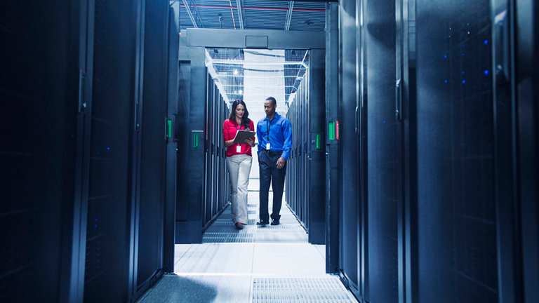 Business people talking in server room