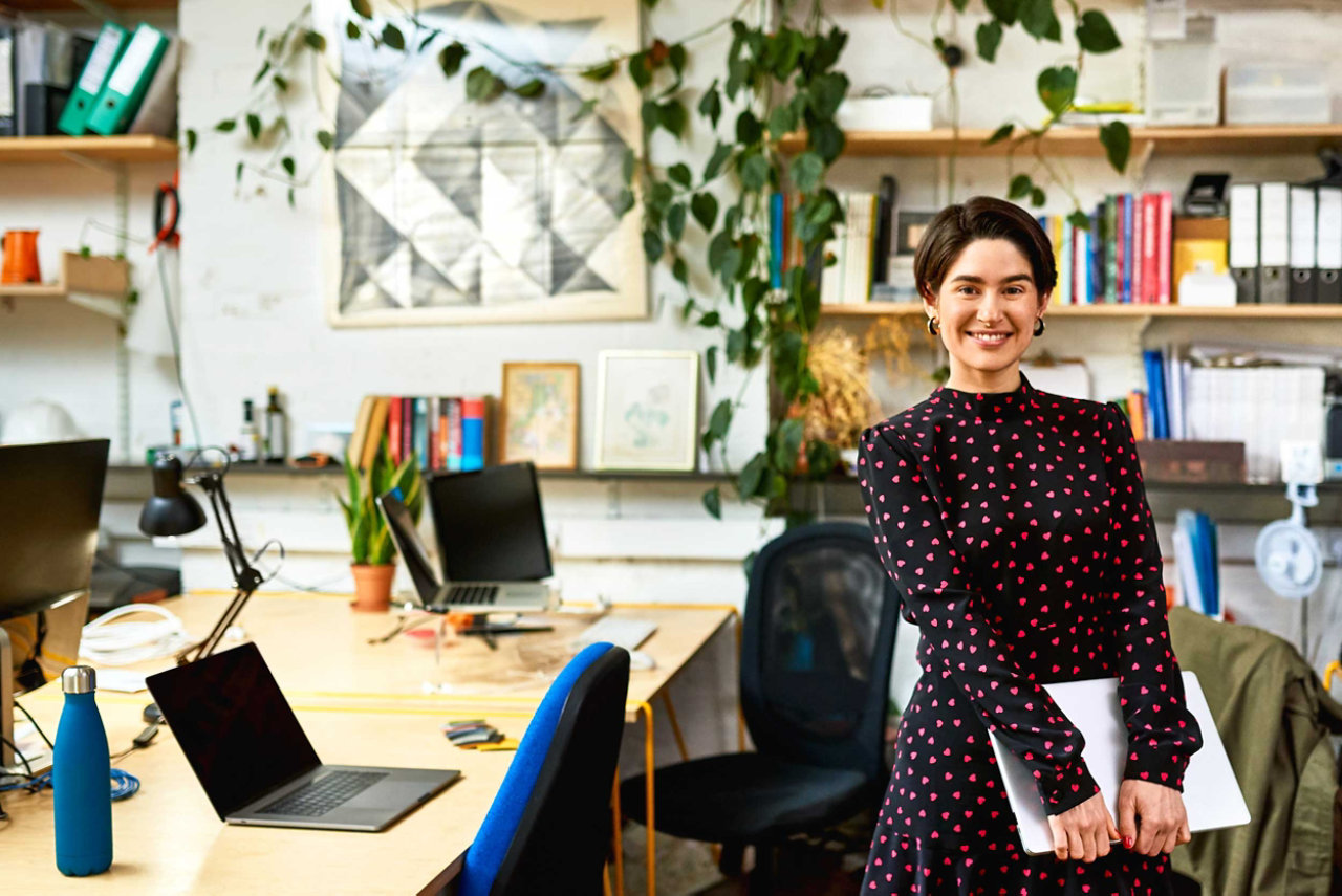 A small business owner in an office with BT Business phone lines