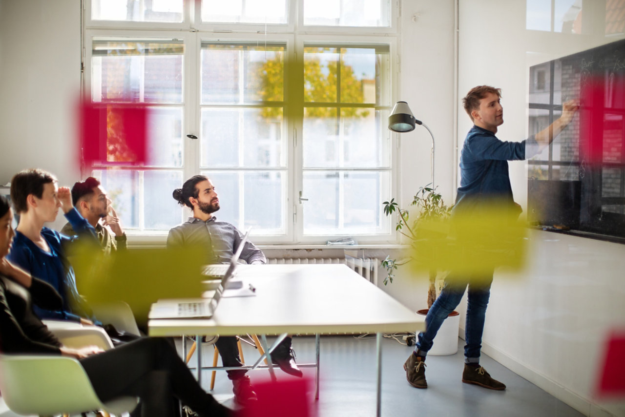 Businessman giving presentation inside boardroom