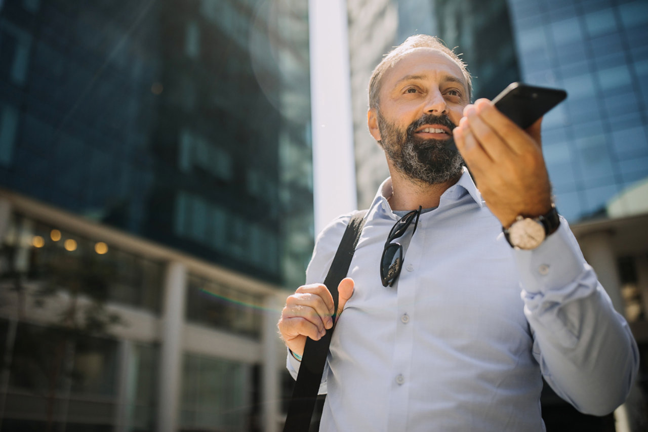 man talking on loudspeaker on his mobile