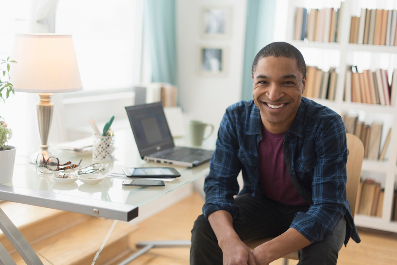 man smiling at desk