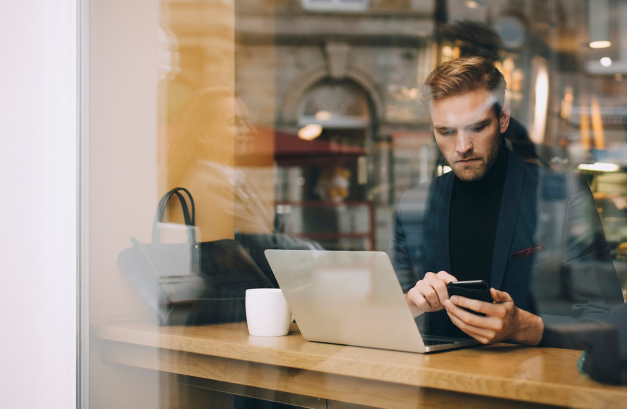 Business man using smart phone in cafe