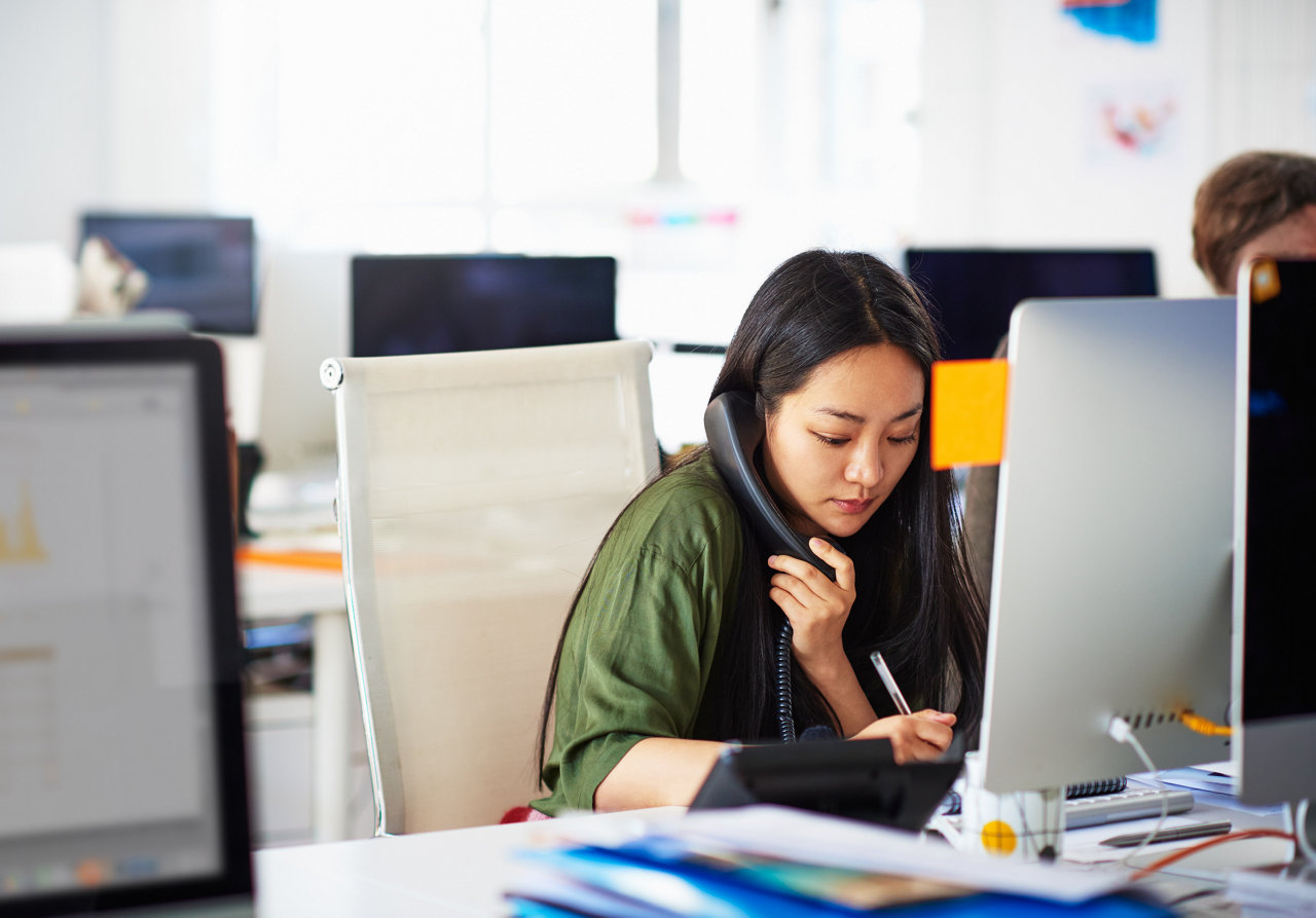 woman takling on phone in office