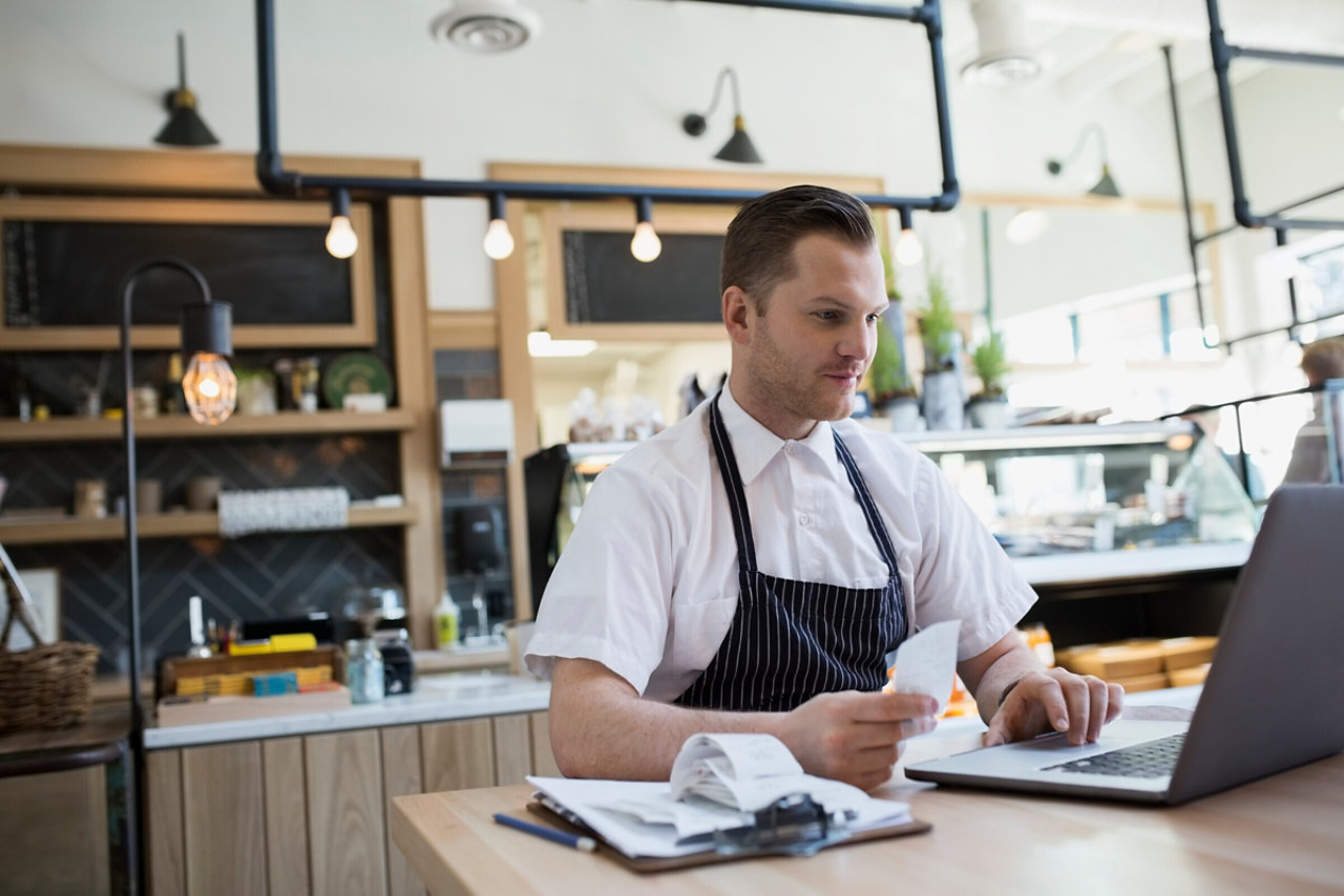 Cafe owner inputting receipts