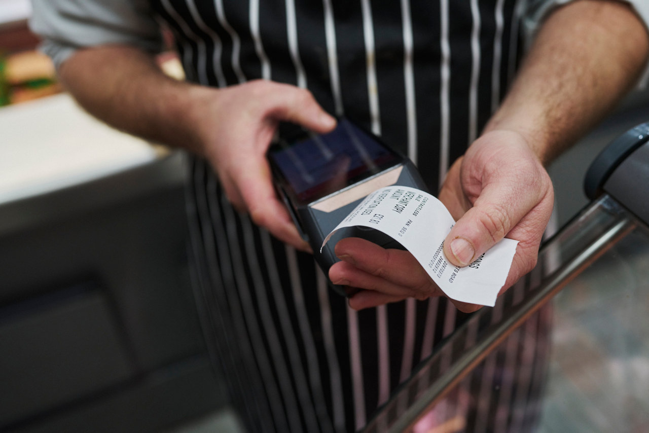 close up of butcher printing receipt