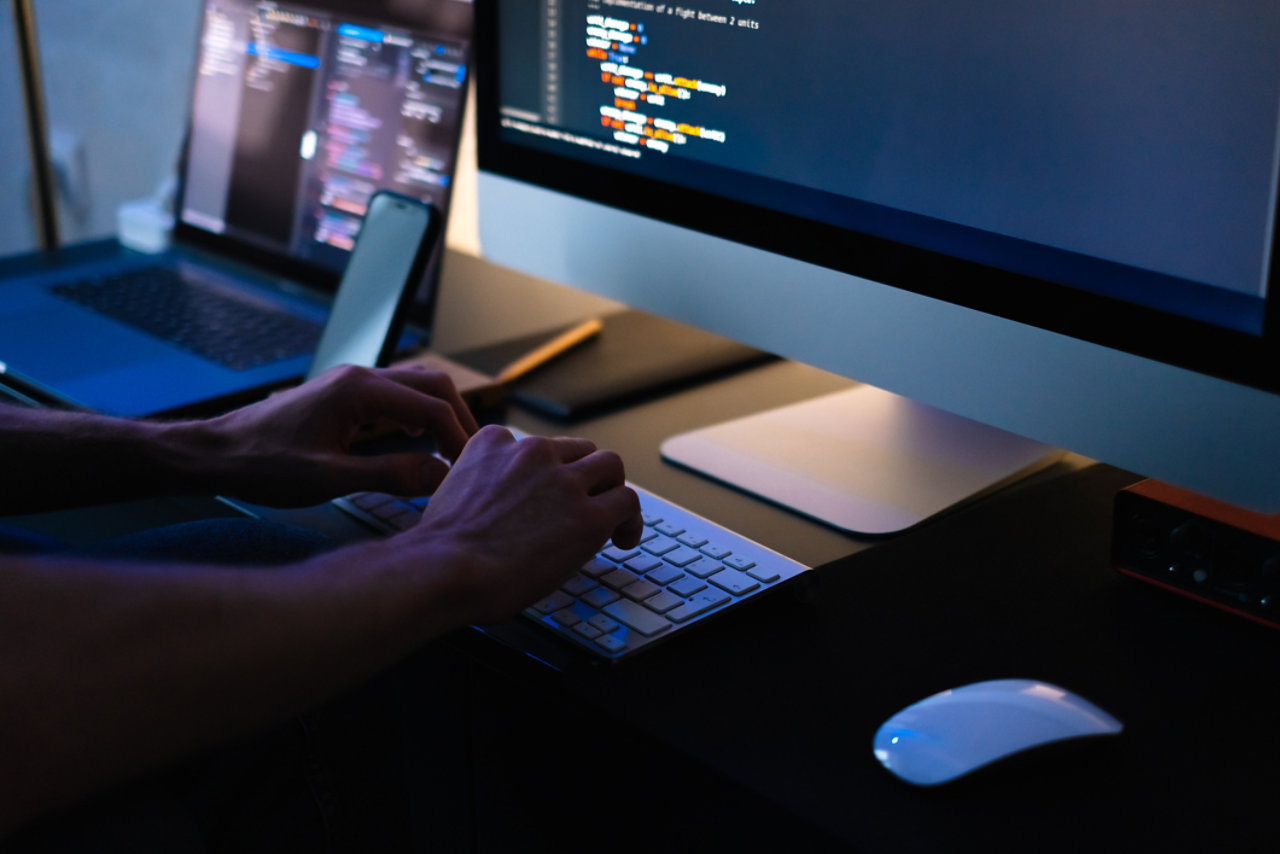 programmer working on a computer at home