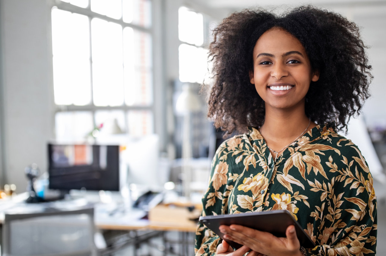 confident businesswoman with digital tablet in office