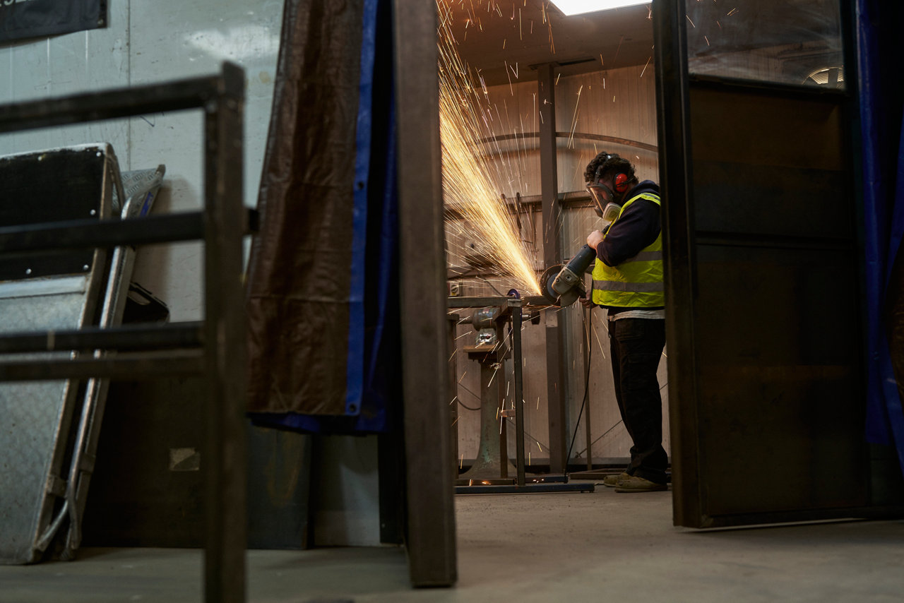 construction worker creating sparks from circle saw