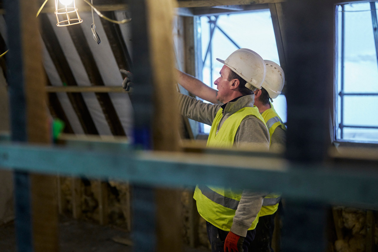 work people discussing on building site