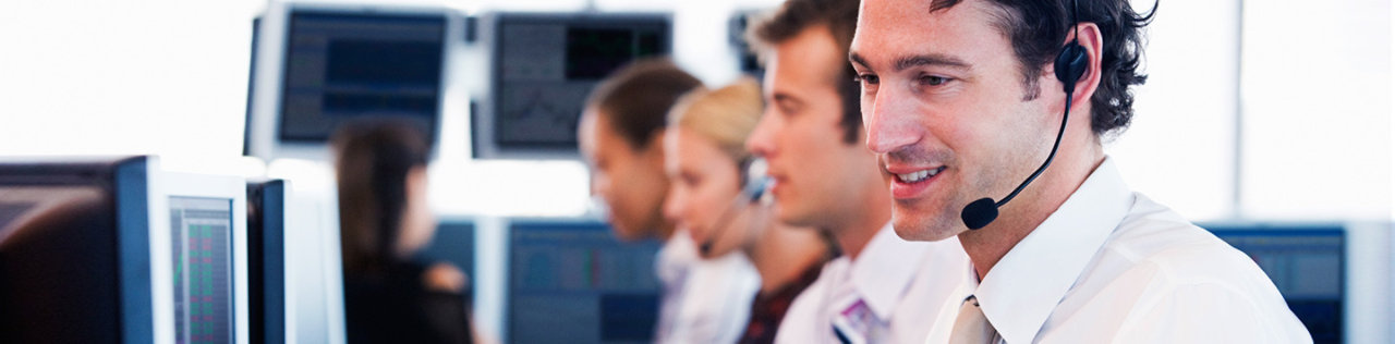 man wearing headset in busy office