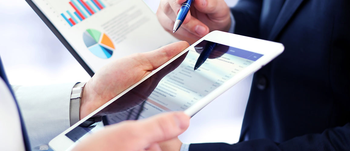 close up of mobile device held by a man with pen pointing at the screeen