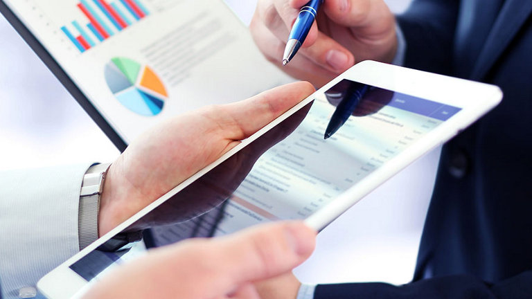 colleagues-working-together-holding-tablet