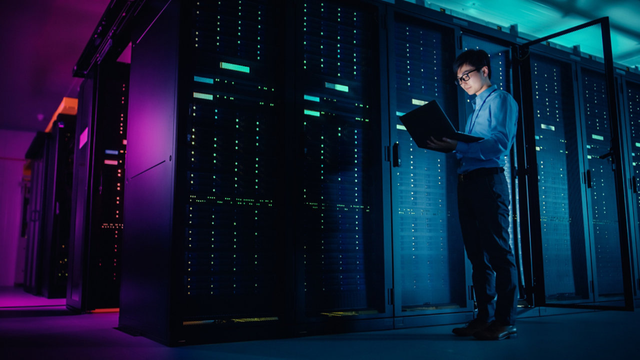 worker with laptop in datacentre