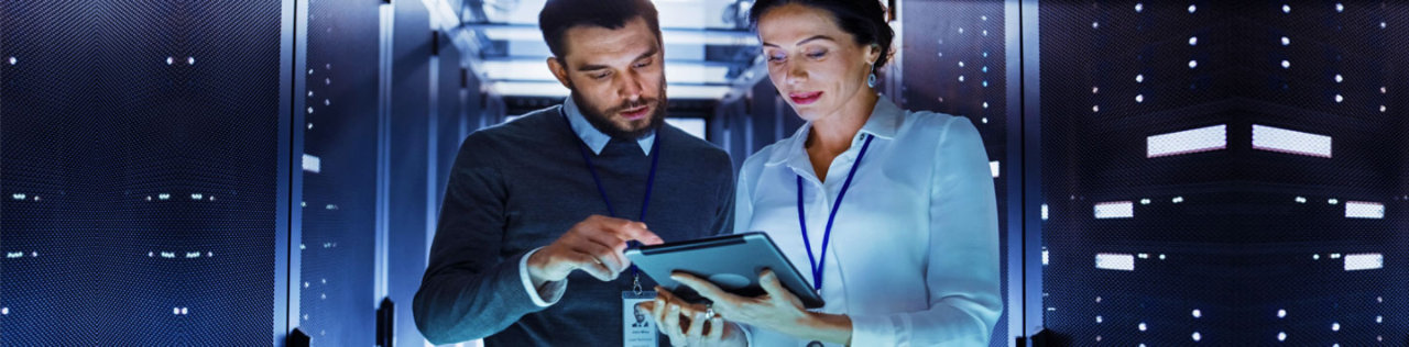 Woman using ipad in server room