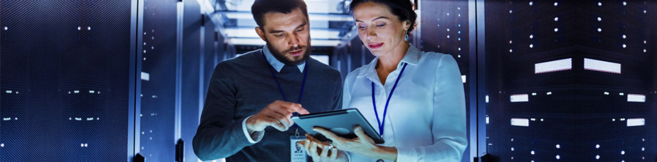 Woman using ipad in server room