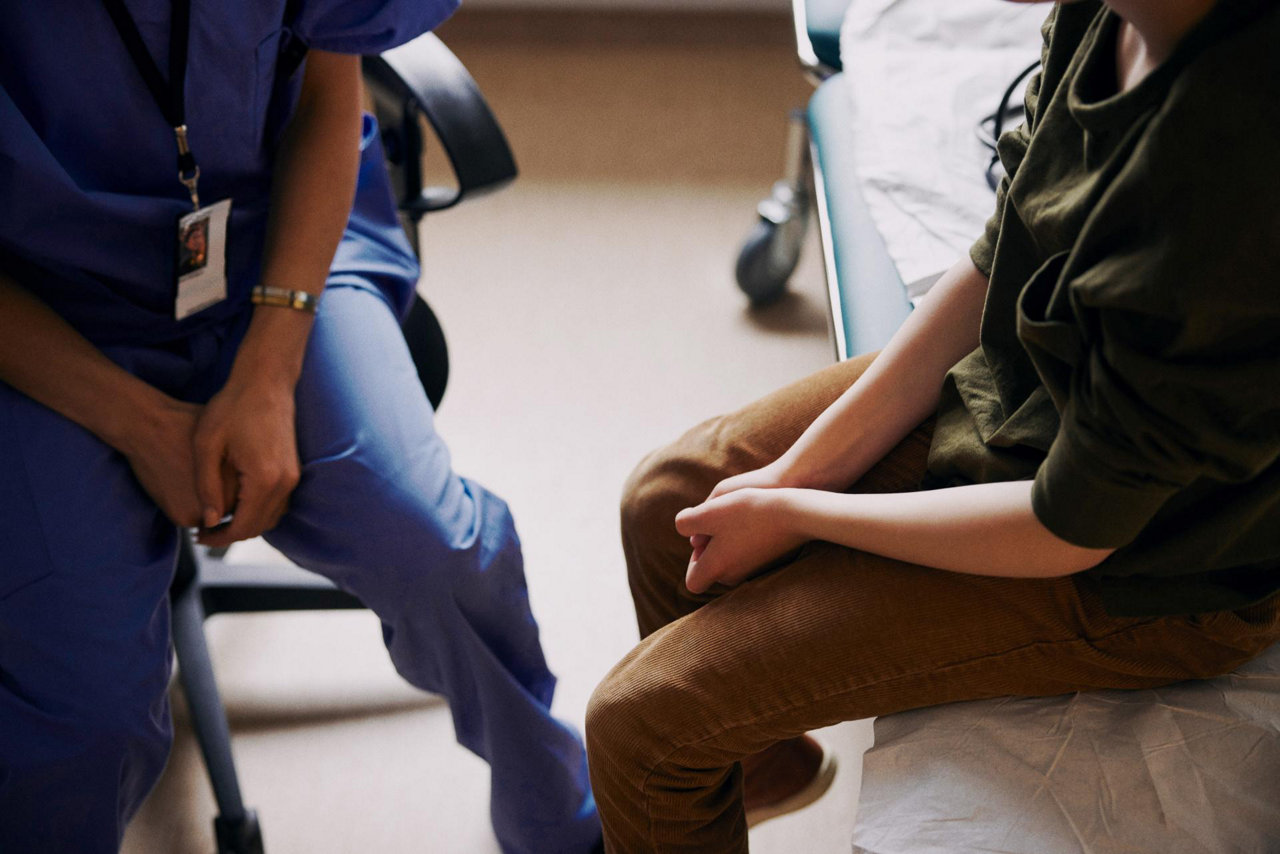 doctor with patient sitting in an exam room