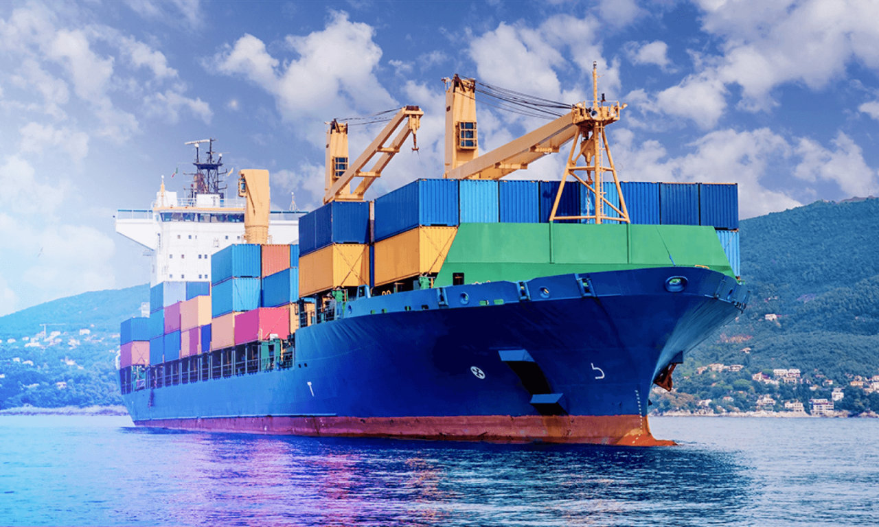 container ship on water with fields in background