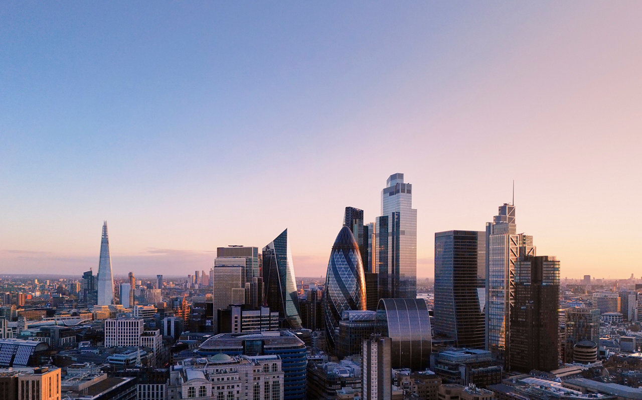 elevated view over city of london skyline at sunset