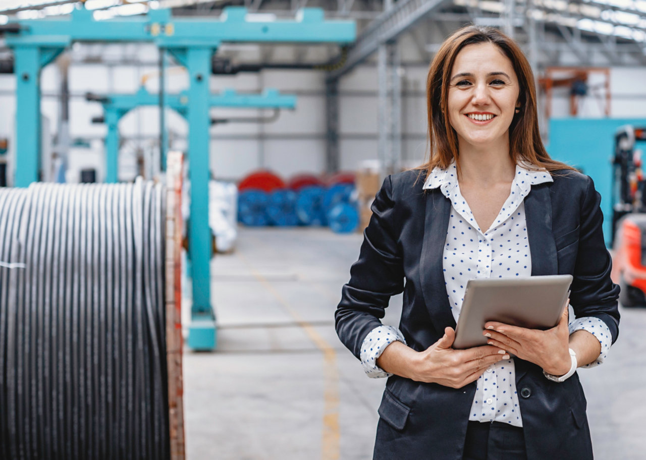 woman holding tablet in fibre optic cable warehouse