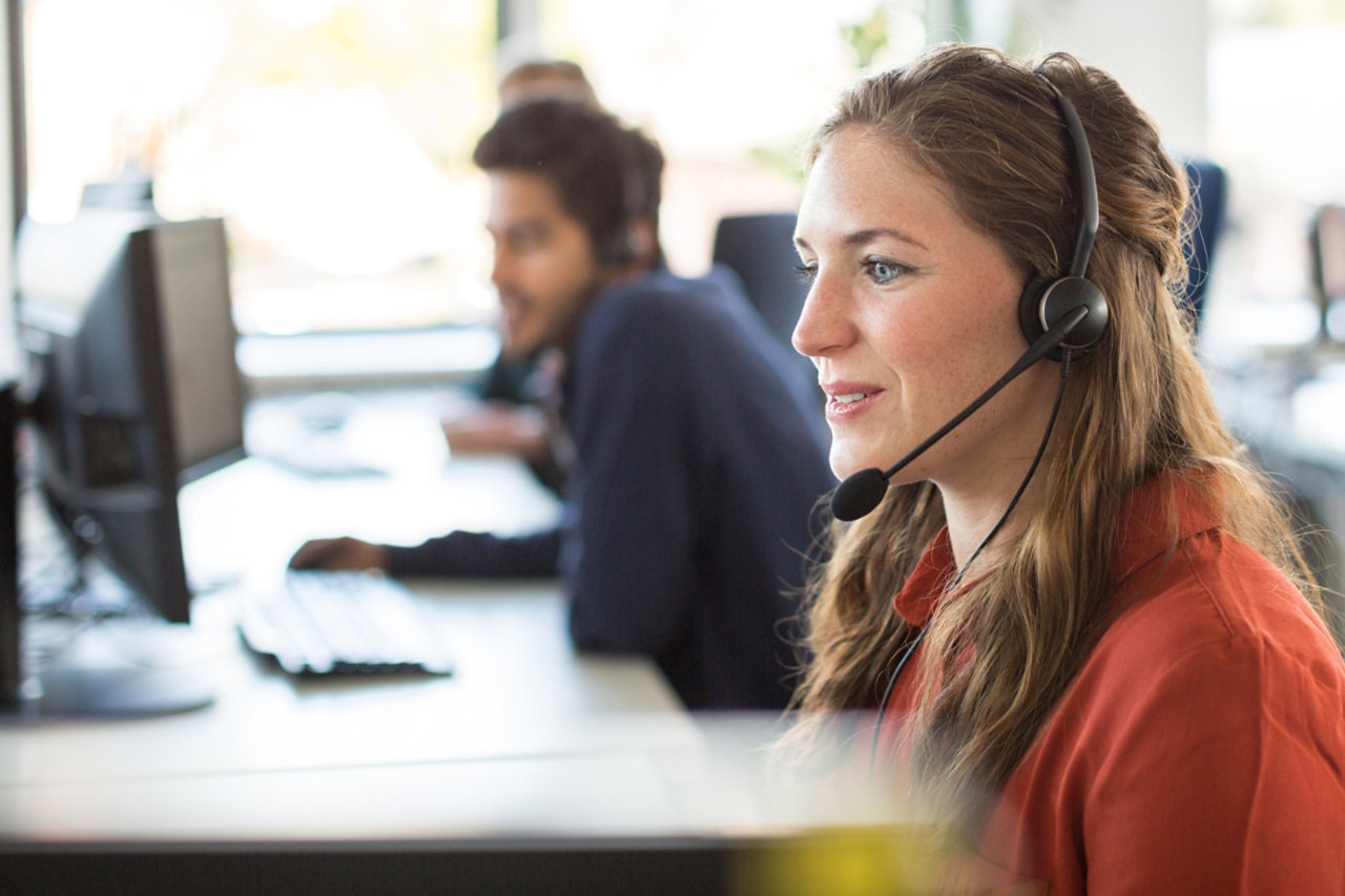 operator on a call with headset in office