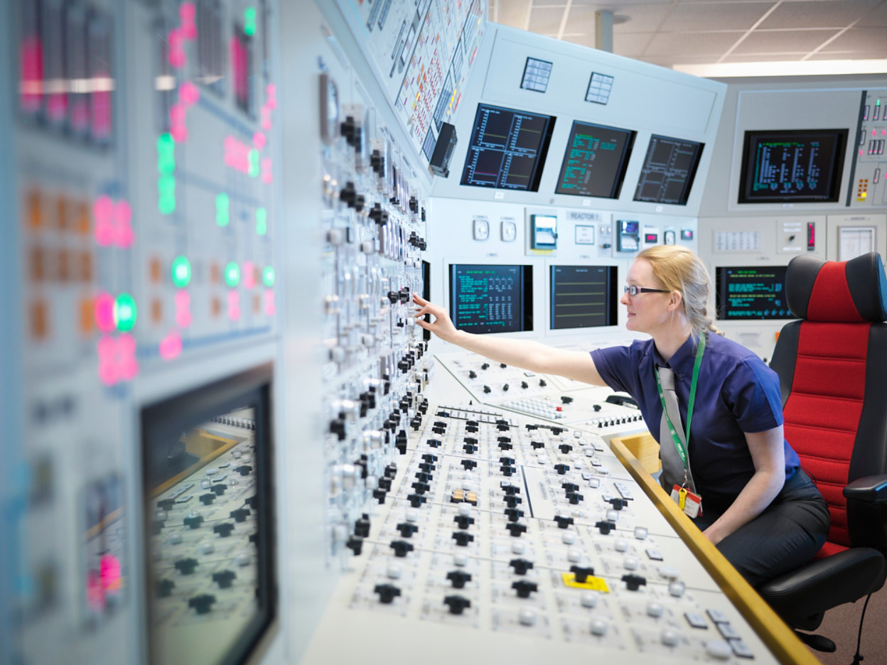 Female operator in nuclear power station control room simulator 