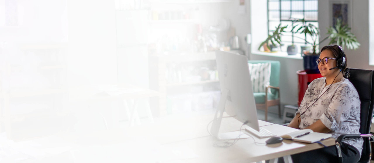 lady on headset working in floral home office