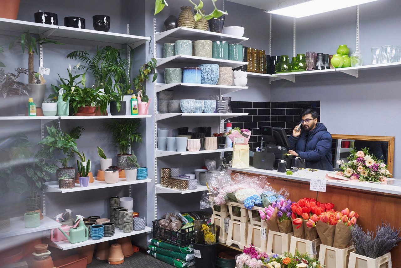 salesperson in flower shop on the phone
