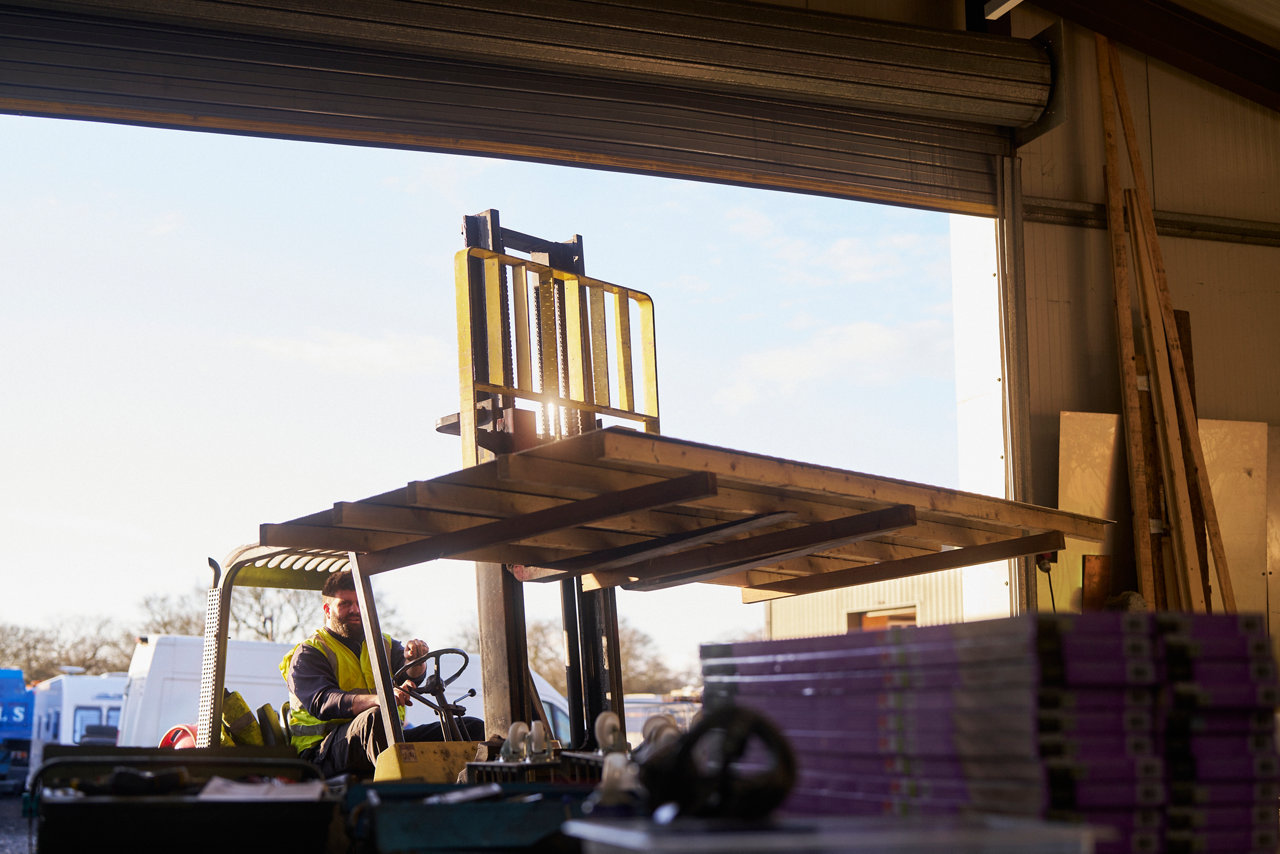 forklift driver raising palette