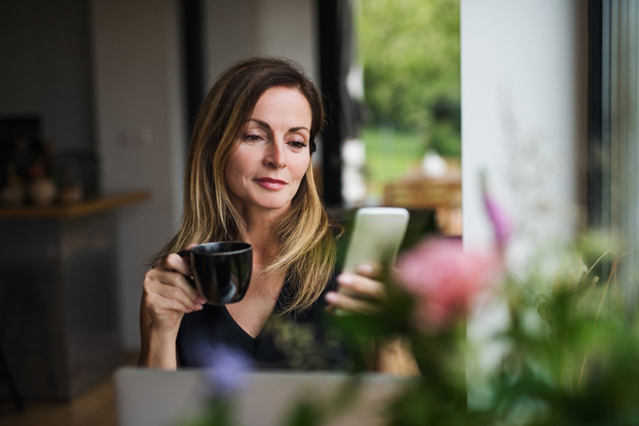 Front view portrait of mature woman with laptop