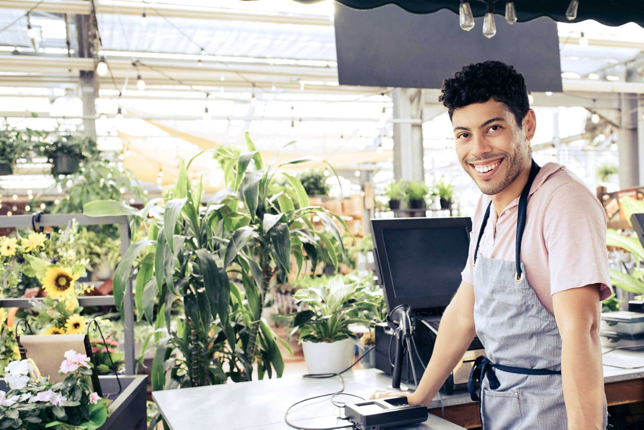 A young cashier smiling