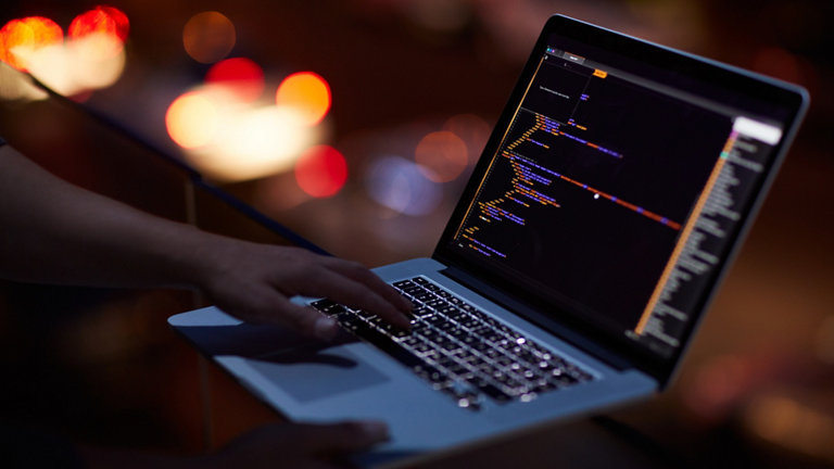 Programmer working on laptop