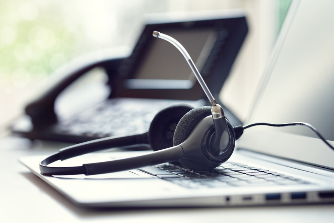 Headset telephone and laptop in call centre