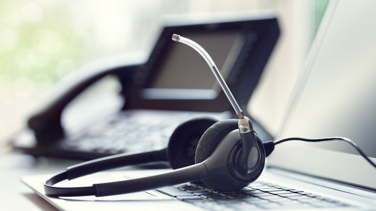Headset telephone and laptop in call centre